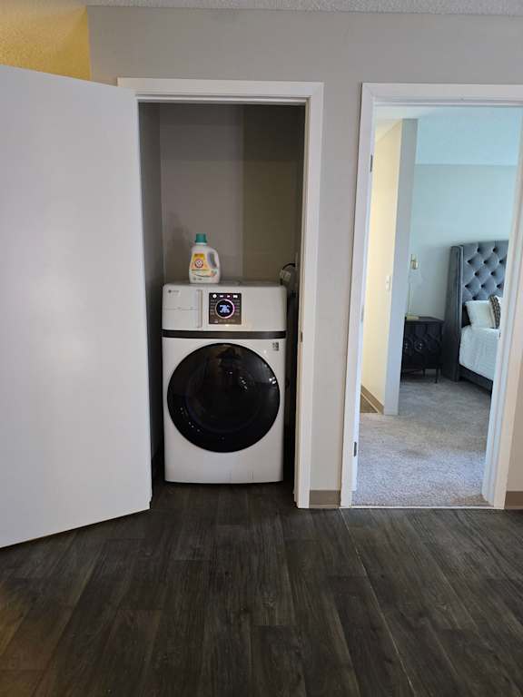 A white washing machine and dryer in a small laundry room.