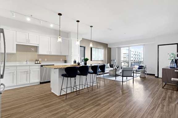 A modern kitchen with a bar area and a dining table.