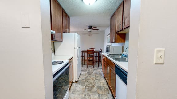 a kitchen with white appliances and wooden cabinets