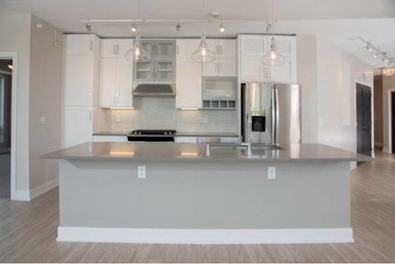 A modern kitchen with a large island in the middle.