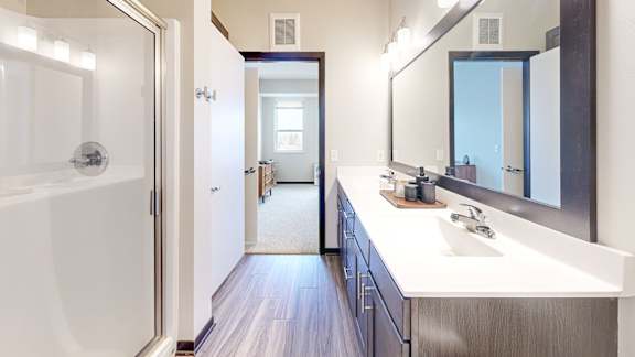 A bathroom with a white sink and a white bathtub.