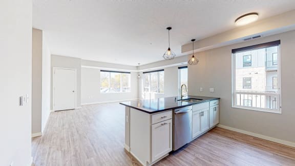 a kitchen and living room with a large window