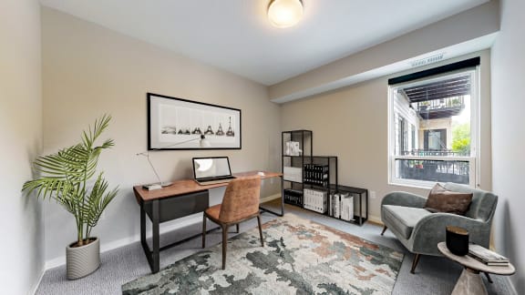 a home office with a desk and a window