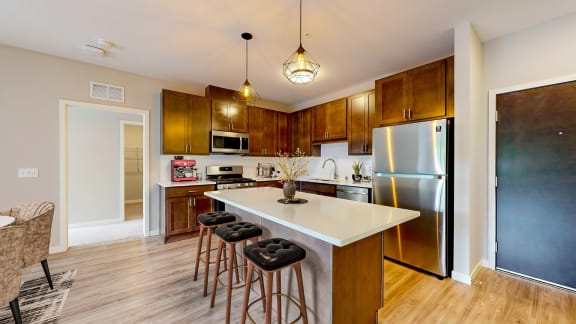 a kitchen with a large island with three stools