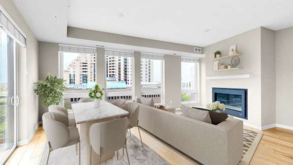 A modern living room with a fireplace and a dining table set up.