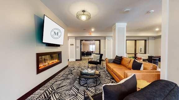 a living room filled with furniture and a fire place