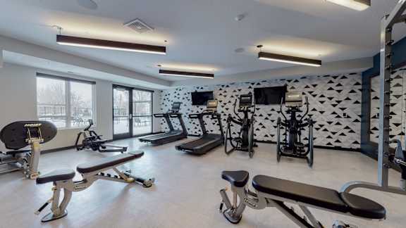 a fitness center with treadmills and other exercise equipment