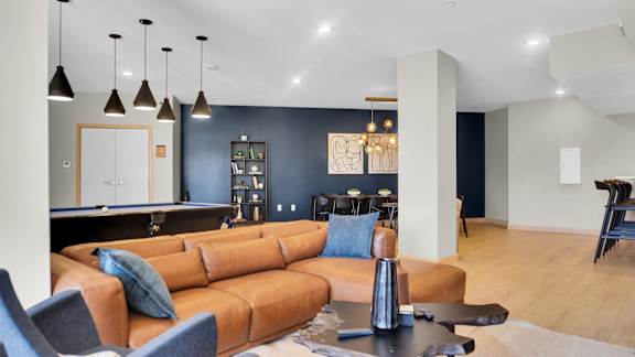 A living room with a brown sofa and a coffee table.