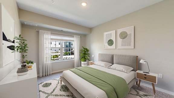 A bedroom with a large bed and a window with curtains.