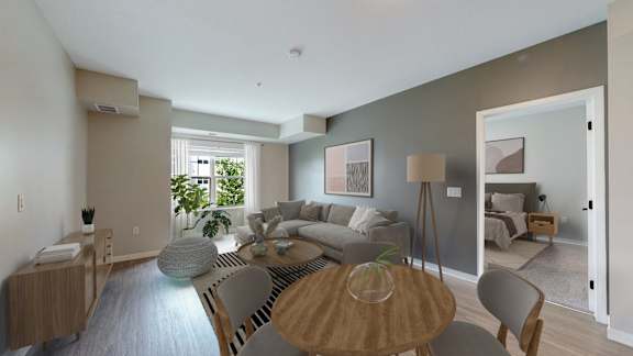 A modern living room with a wooden table and grey chairs.