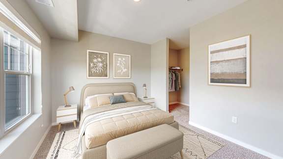 A bedroom with a large bed and a window.