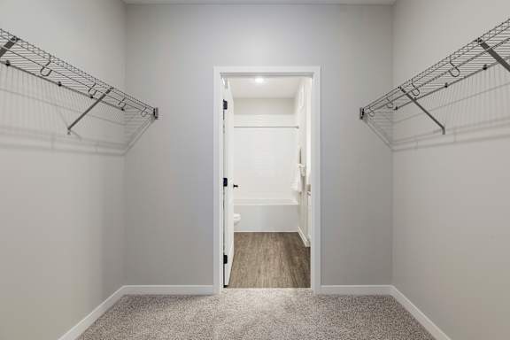 A white door is open in a room with white walls and a carpeted floor at The Barnum Apartments, White Bear Lake, 55110