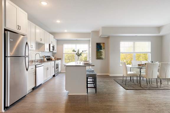 A modern kitchen with dinning area at The Barnum Apartments, White Bear Lake, MN,  55110