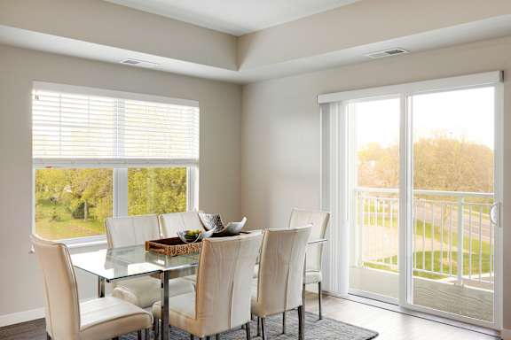 A dining room with large windows at The Barnum Apartments, MN, 55110
