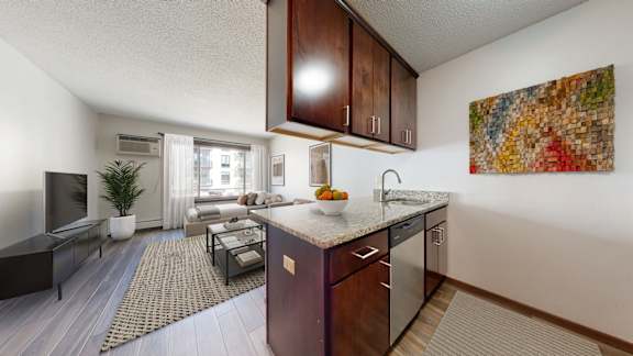 A kitchen with a brown counter top and a painting on the wall.