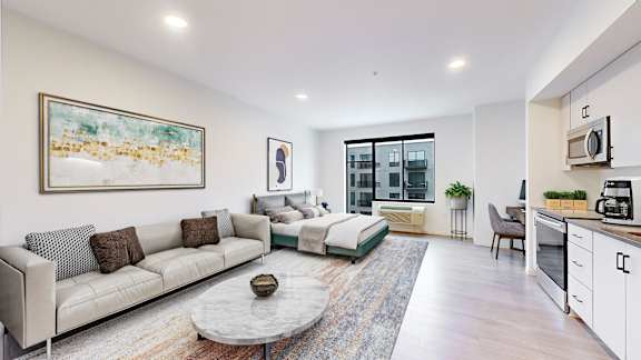 A modern living room with a grey sofa and a coffee table.