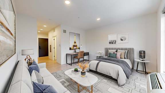 A modern bedroom with a large bed and a couch.