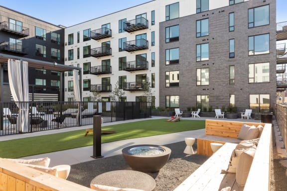 an outdoor patio with a firepit and lounge furniture at the bradley braddock road