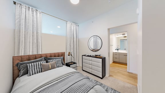 a bedroom with a large bed and a mirror