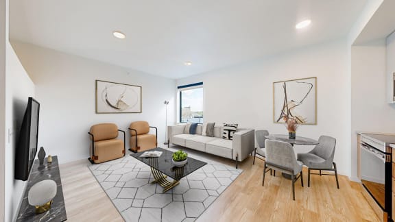 a living room with a couch and a table with chairs