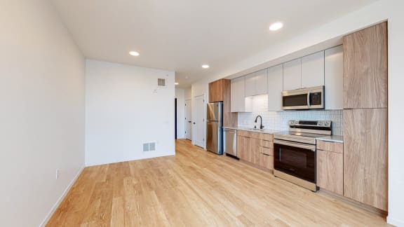 Modern Kitchen With Stainless Steel Appliances And Double Door Refrigerators at The Mason, St. Paul, MN
