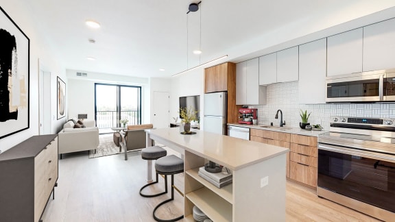 a kitchen with a large island and a living room