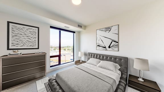 a bedroom with a bed and a large window
