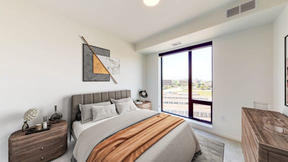 a bedroom with a large bed and a large window