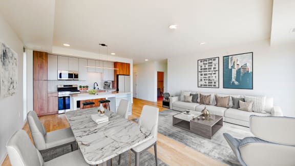 a living room and dining room with a table and chairs