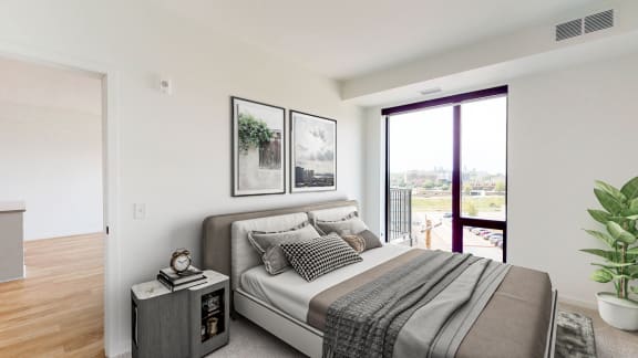 a bedroom with a bed and a large window