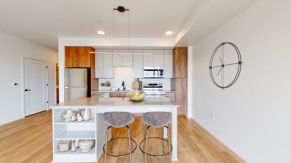 a kitchen with a island and three stools