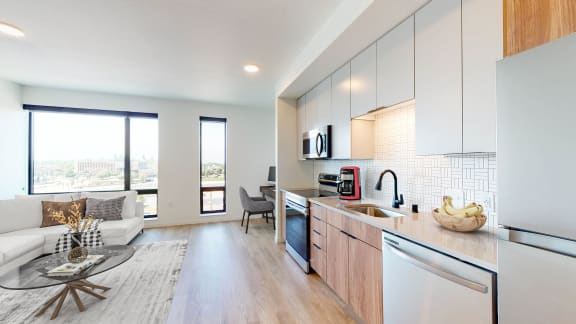an open kitchen and living room with a view of the city