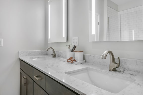 a bathroom with two sinks and two mirrors