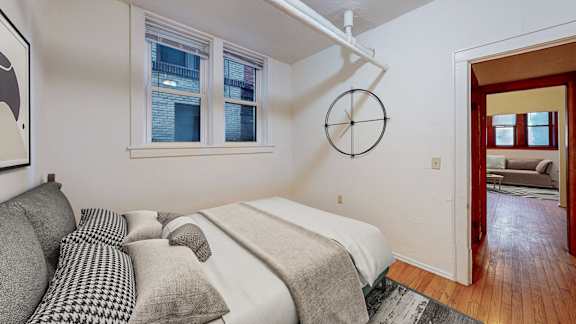 A bedroom with a bed and a couch.