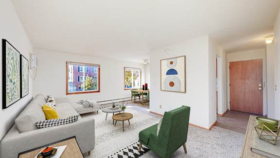 a living room with a gray couch and a green chair