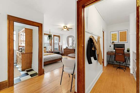 A bedroom with a bed, desk, and chair.