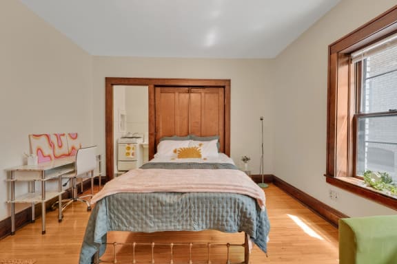 a bedroom with a bed and a desk
