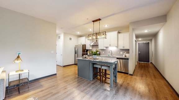 A kitchen with a table and chairs in the middle of the room.