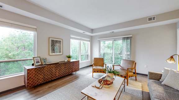 A living room with a couch, chairs, and a table.