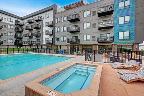 a swimming pool in front of an apartment building