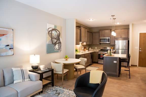 a living room and kitchen with a couch and a table