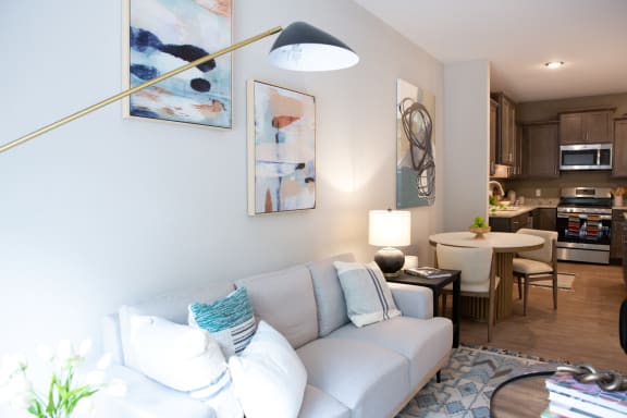 a living room and dining room with a couch and a table