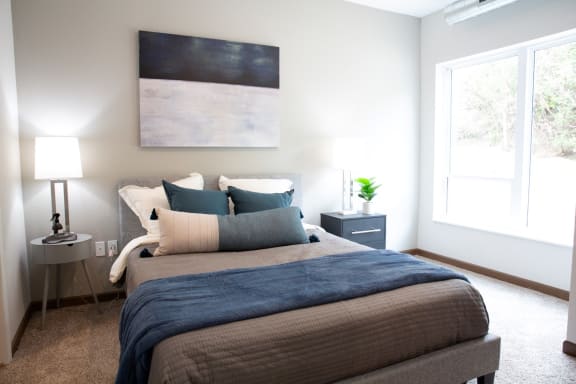 a bedroom with a bed and a painting on the wall