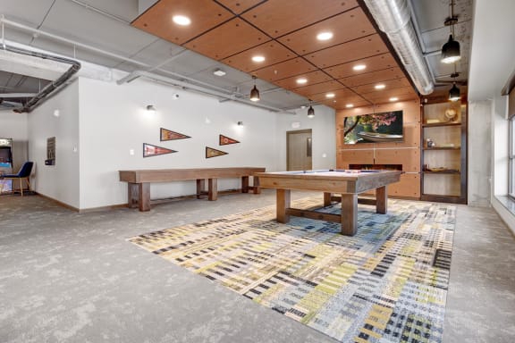 a games room with two pool tables and a foosball table