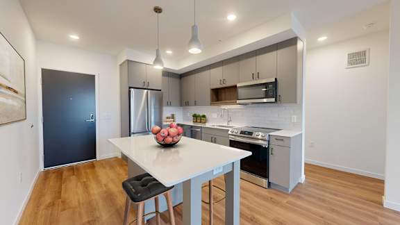 A modern kitchen with a dining table and chairs.