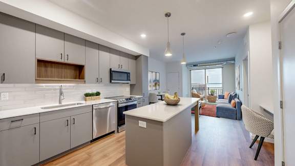 A modern kitchen with a dining area in the background.at Tyler Street Stacks, Minnesota