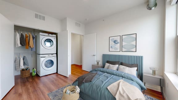 a bedroom with a bed and a washer and dryer at Tyler Street Stacks, Minneapolis