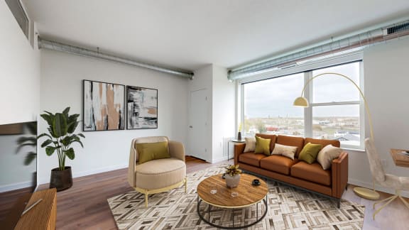 a living room with a couch and a large window at Tyler Street Stacks, Minneapolis, 55413