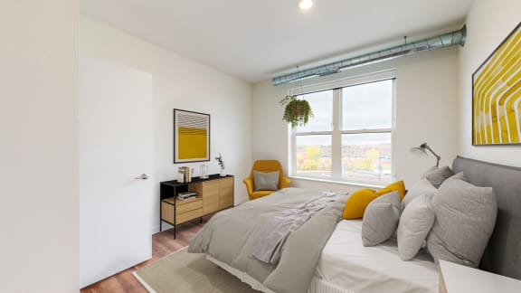 a bedroom with a large bed and a large window