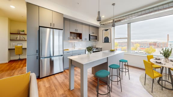 a kitchen with a large window and a table with chairs